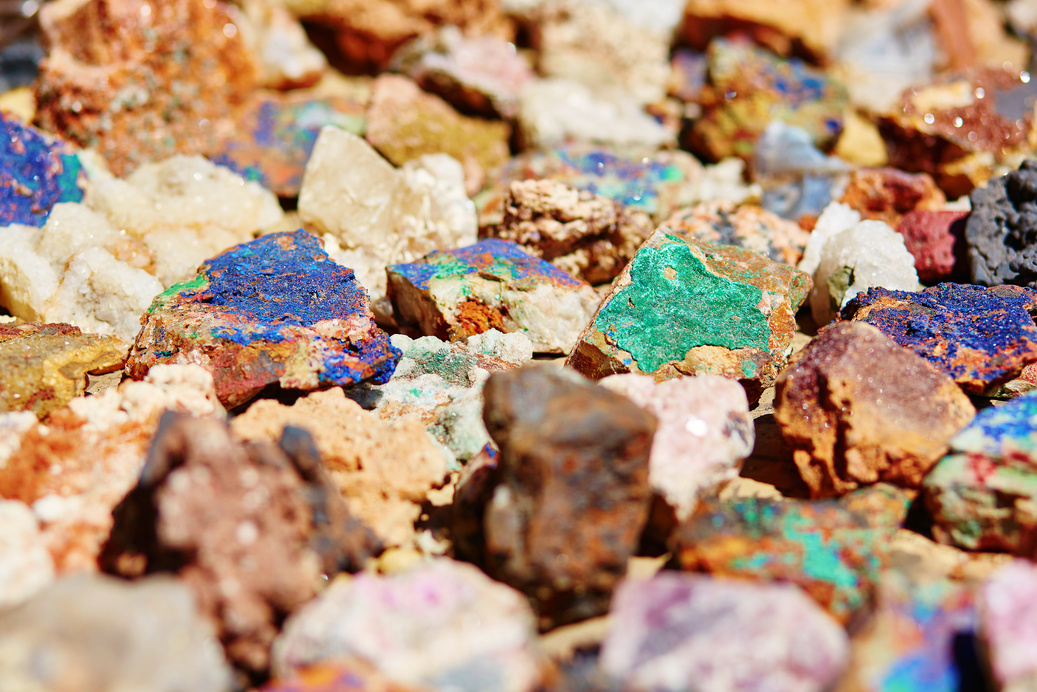 a pile of colorful rocks sitting on the ground